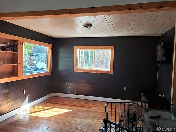 Freshly painted Living room with lots of light and a wood stove for cozy winter warmth.