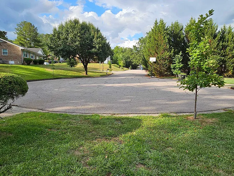 Quiet cul-de-sac setting with mature trees, sidewalks, and spacious lawnsideal for easy parking and neighborhood walks.