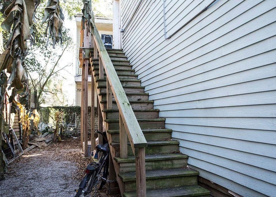 Upstairs walking up to front door, with wrap around balcony. There is a gate on the street level prior to entry at this point.