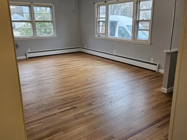 Large, open, bright living room with amazing hardwoods!