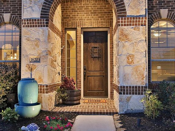 There's a lovely covered entry with stone surround and full wood front door.