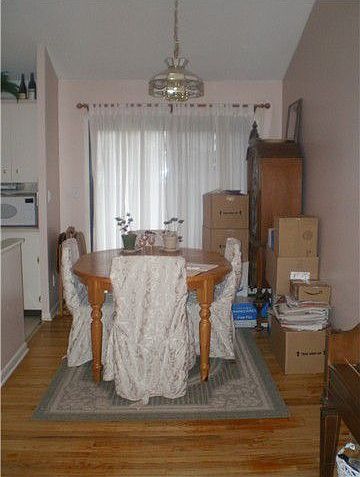 Vaulted dining room with hardwood flooring