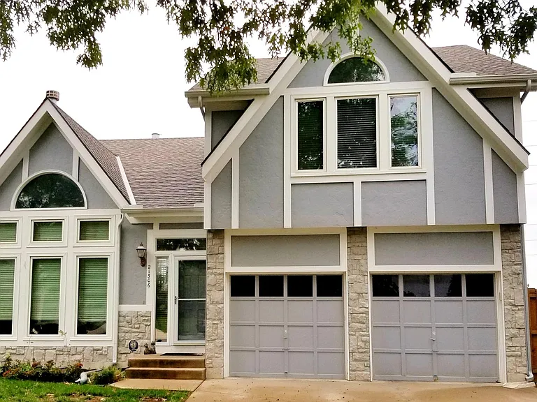 Front view of the house. All windows (aside from the ones on top/side of the front door) were recently installed.