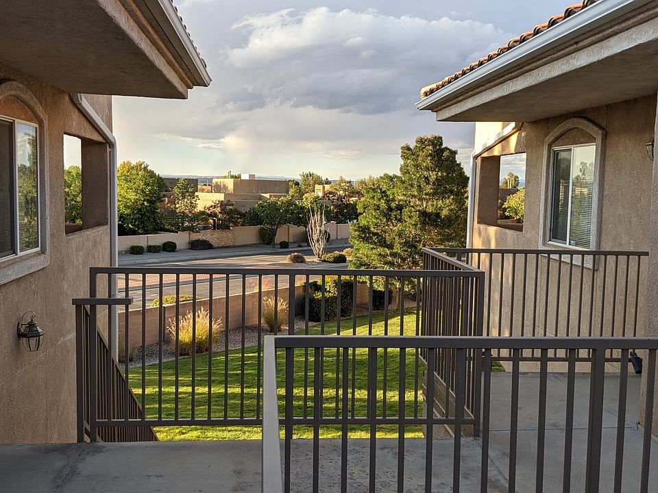 View from walkway outside front door. Well kept grass area below,