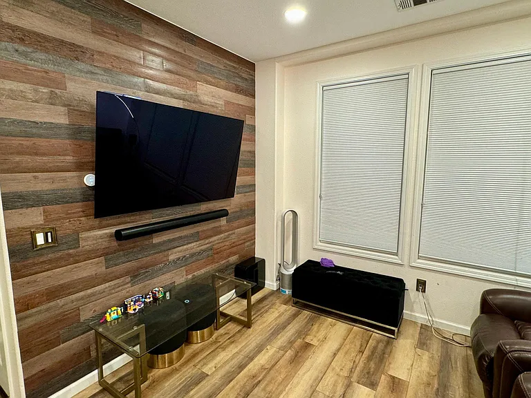 Wooden plank covered wall with TV stand