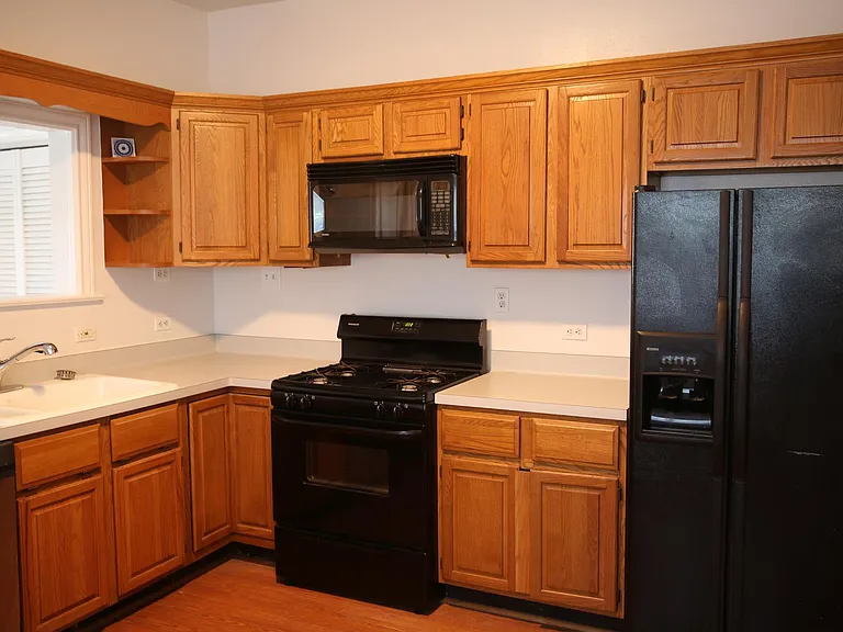 Kitchen with oven/stovetop, microwave, refrigerator/freezer,