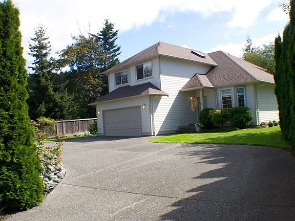 This home welcomes you in with the meandering driveway. Located on a private cul-de-sac.