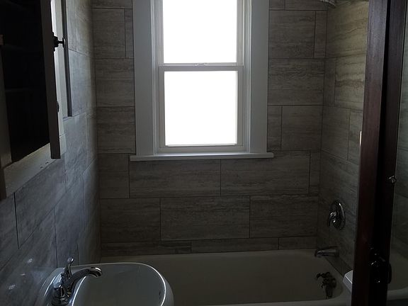all new tile on walls and floor, new vanity and toilet, sizeable closet in bathroom for storage