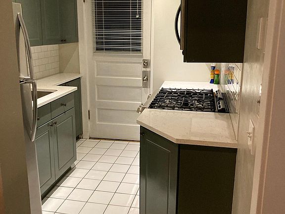 Stainless steel appliances, quartz countertops, and subway tile backsplash