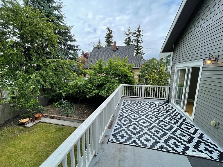 Deck above covered insulated storage area provides plenty of storage for bikes and strollers, bbq and eat just off the kitchen, overlooking raised bed garden, with mature plum and apple trees!