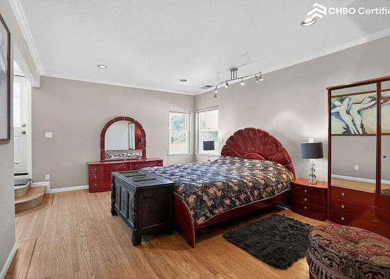 The upper level primary bedroom has a private balcony
