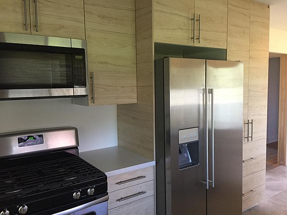 New kitchen cabinets, new fridge, new gas range 