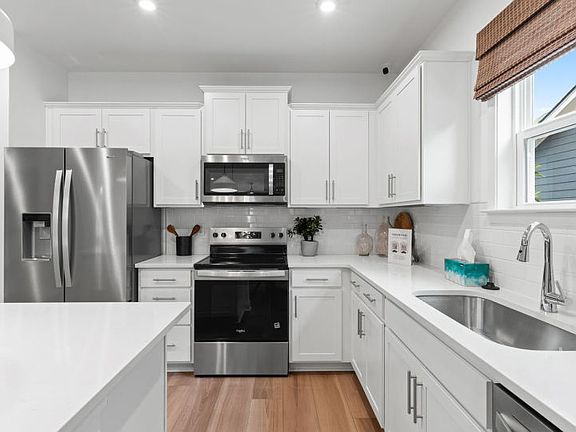 Stainless Steel Kitchen Appliances extra counterspace for cooking. Model Home Representation.