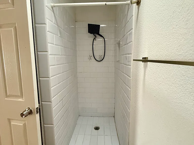 Shower in 2nd BR with towel rack on right wall, just outside the shower.
Note: this shower is being re-grouted and deep cleaned before new tenants move in.