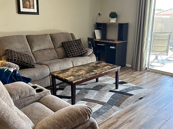 Living room facing the sliding door to patio.