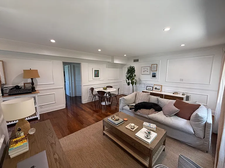 Living room with door to hallway that leads to bathroom and bedrooms