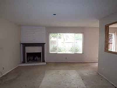 Old Front room, tore down wall, pulled up carpet, tiled over white brick 
