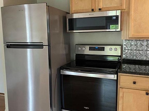 Refrigerator with built-in icemaker, smooth-top range and over-range microwave with exhaust fans
