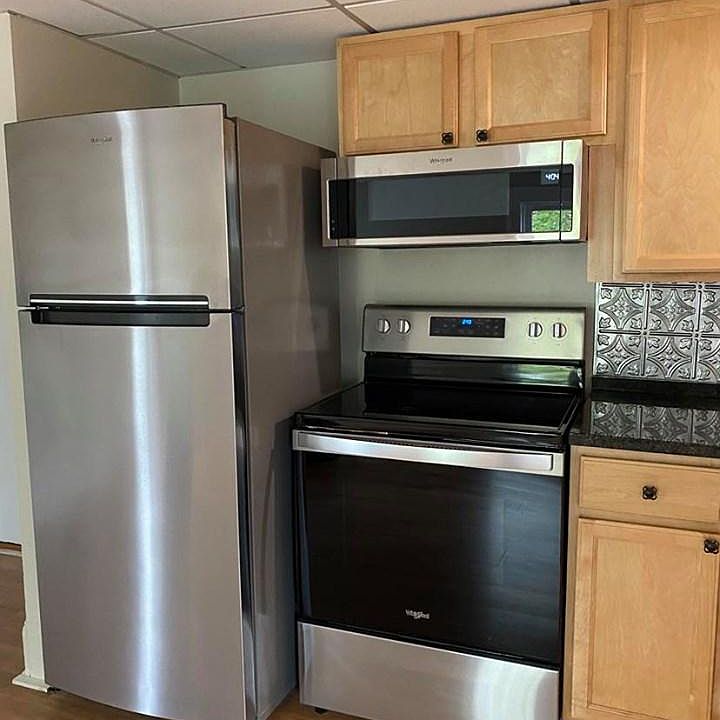 Refrigerator with built-in icemaker, smooth-top range and over-range microwave with exhaust fans