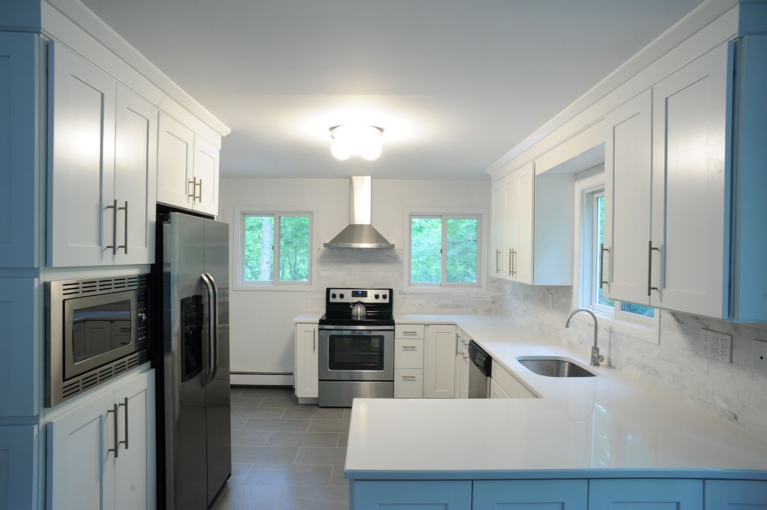  Modern kitchen w/quartz countertops, marble tile, slate floor, & stainless steel appliances