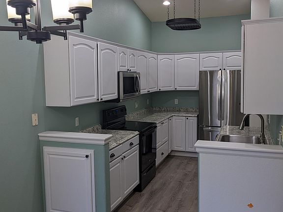 Updated kitchen with new appliances, countertops, sink and floor.