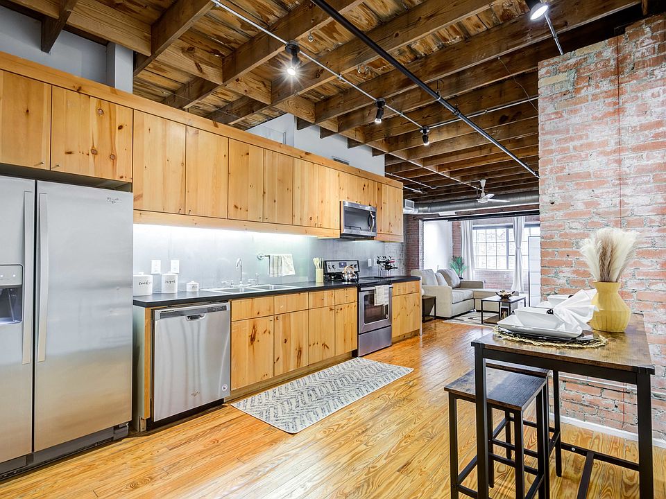 Renovated Lofts with exposed steel beams and brick accents