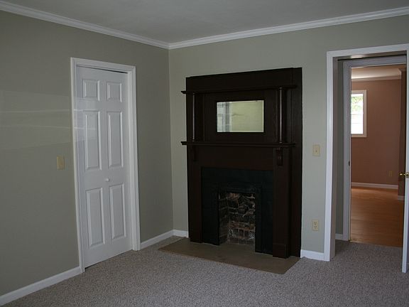 Bedroom with original fireplace mantel