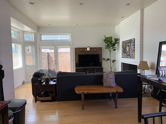 Looking at the living room from the kitchen. Open floor plan leading to the side yard.