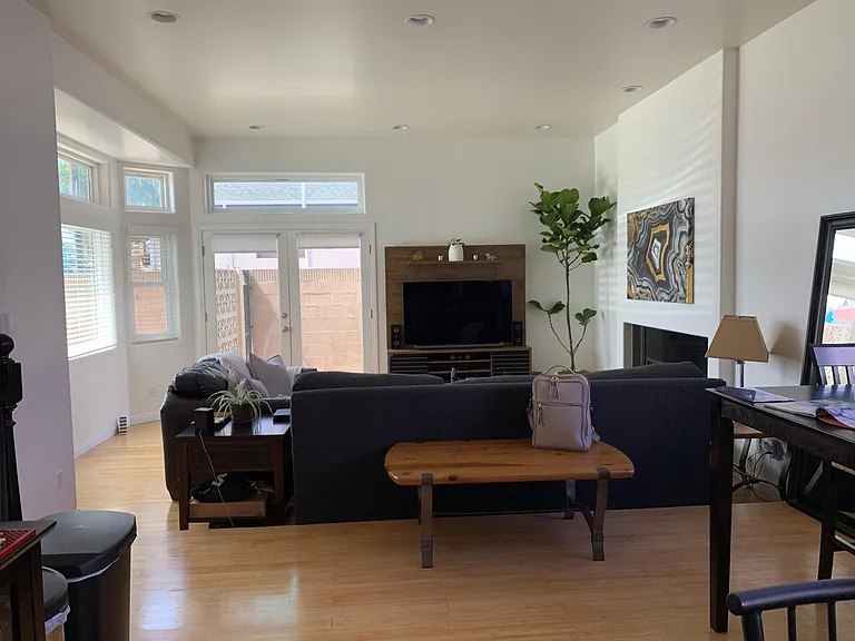 Looking at the living room from the kitchen. Open floor plan leading to the side yard.