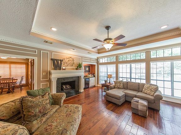 Hardwood floors and natural light flowing from the wall of windows add character and charm to this gorgeous home.