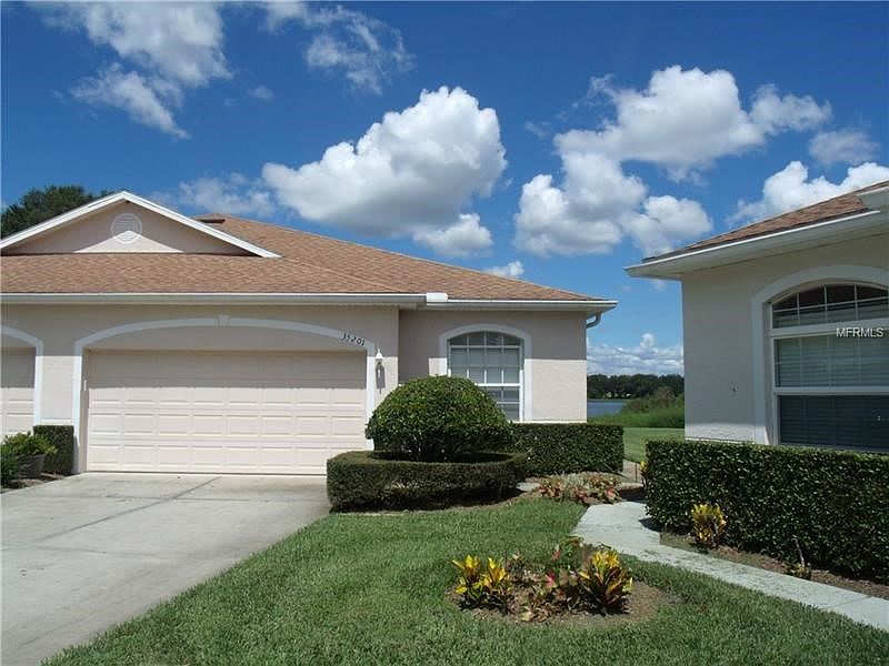Front Exposure with view of Lake in the background.  Entrance door on the right side.