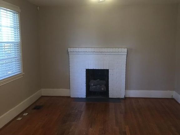 Large family room with Hardwoods and gas logs.