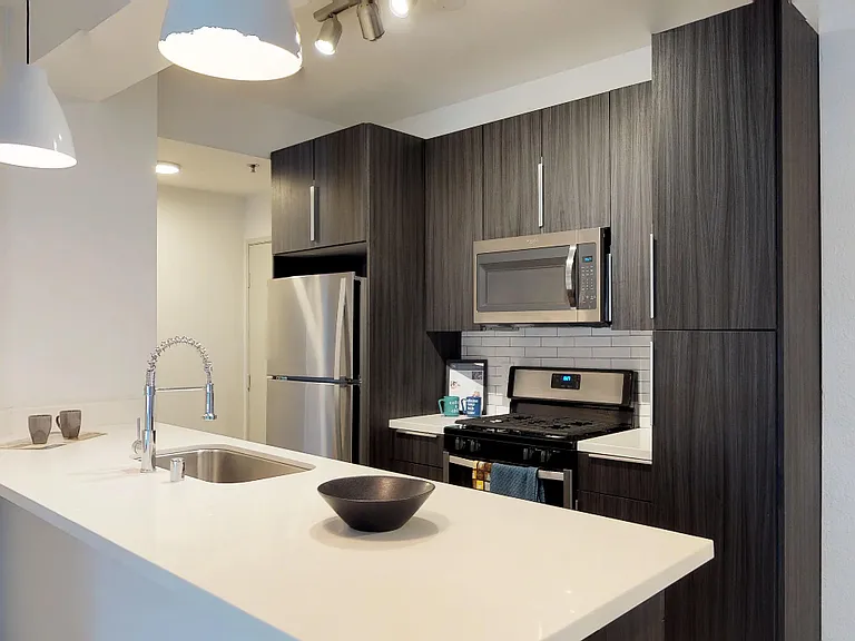 Modern kitchen featuring dual tone cabinetry and large island.