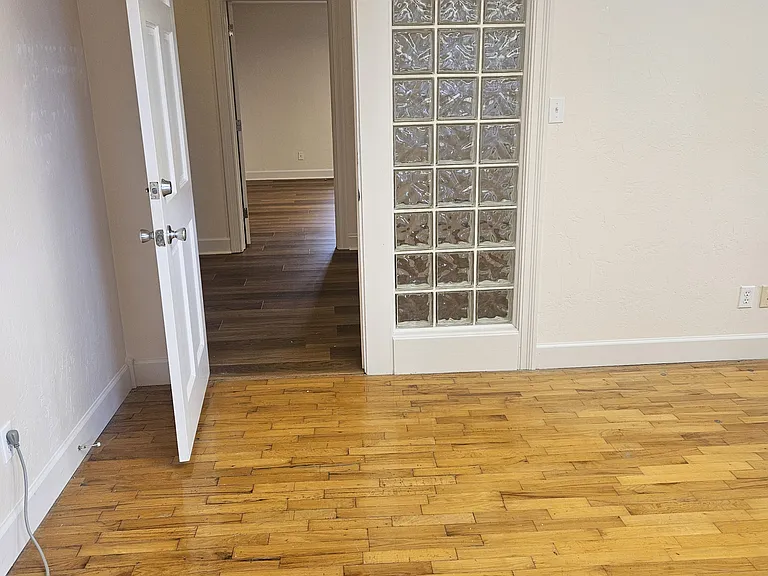 Bedroom 2 with original hardwood floors.