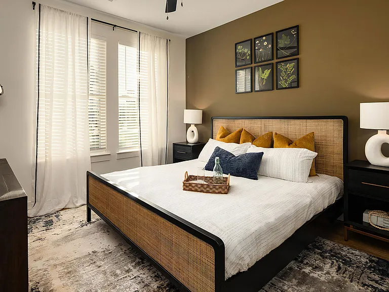 Stylish Bedroom Featuring Woven Bed Frame and Botanical Artwork