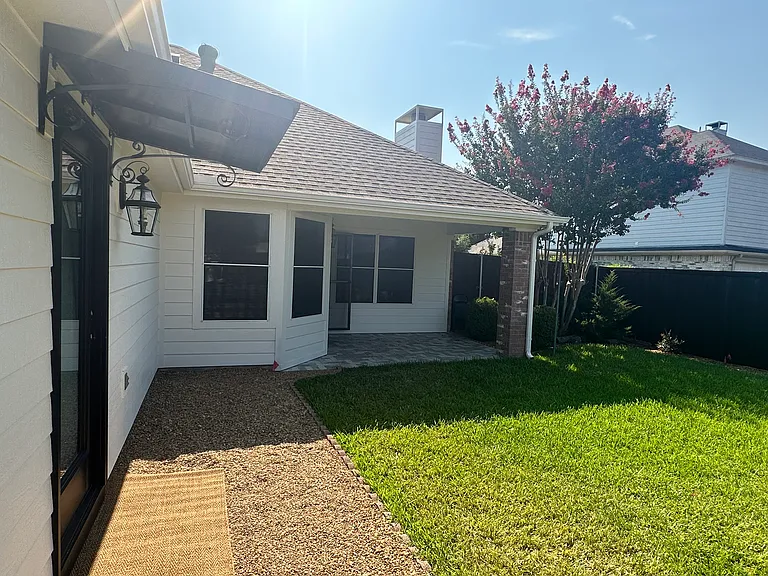 Backyard 
Canopy above designated garage entry door.