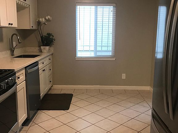 Kitchen with new appliances including gas stove, dishwasher, bottom freezer refrigerator and microwave.