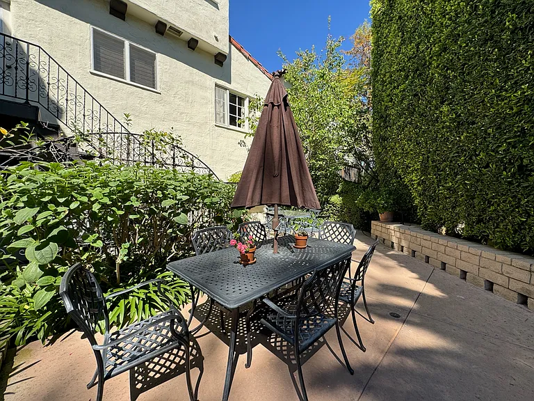 Courtyard patio - shared courtyard dining area surrounded by greenery.