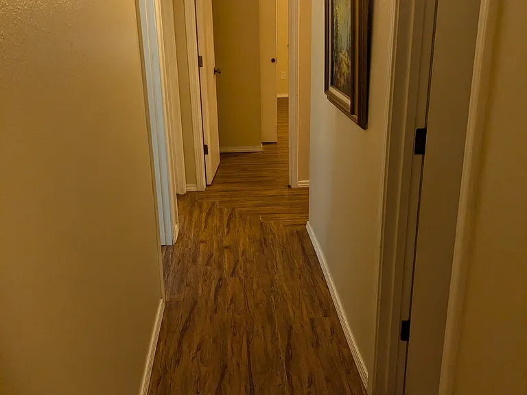 Hallway from Primary Bedroom, looking to Bedrooms 2, 3, & 4 as well as family bathroom