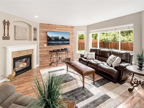 Living Room with corner gas fireplace, tile surround, art nook above.