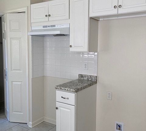 Kitchen showing laundry place for stove and frig