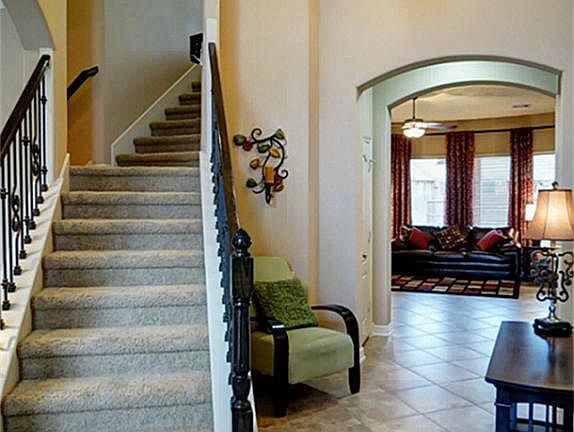 Beautiful entry way with lead glass door, tile on a diagonal and wrought iron spindles. This home ha