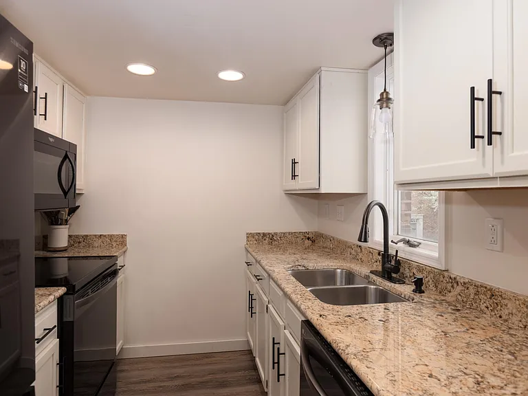 Kitchen (all appliances included; full-sized dishwasher). Window faces back of house.