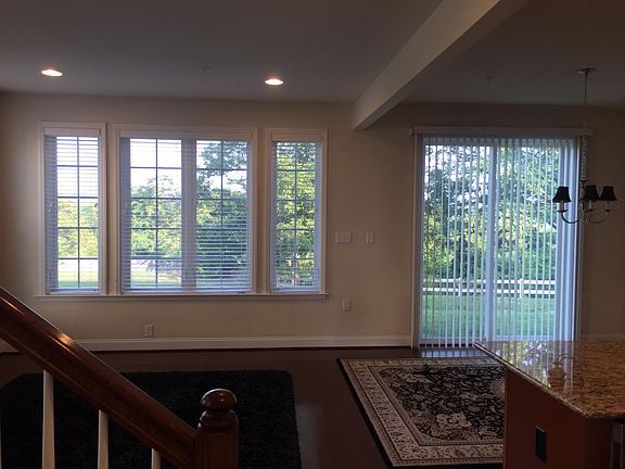 Granite counters, hardwood floors, wood blind window coverings throughout