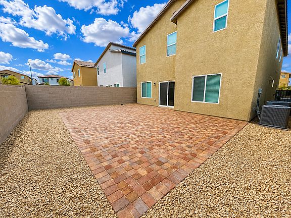 Low-maintenance backyard landscaping with a generously sized paver patio