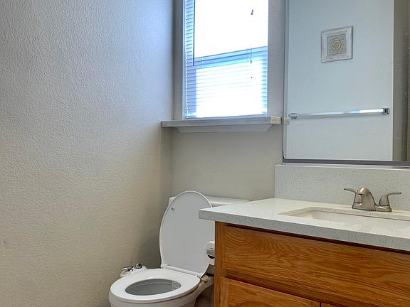 Half Bath with ceramic tiled floor and quartz counter top