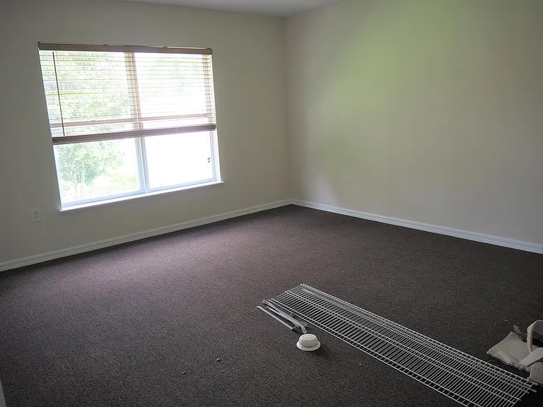 Bedroom 4 with closet shelving being installed.