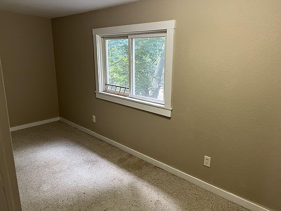 Small carpeted room off of the kitchen