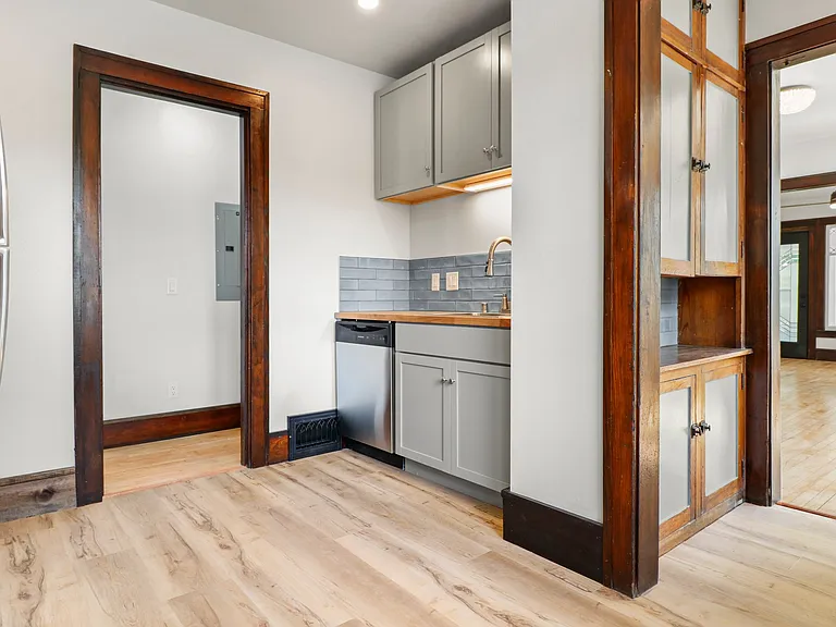 Upstairs butler's pantry leading to dining room. shot of the sink and dishwasher.
