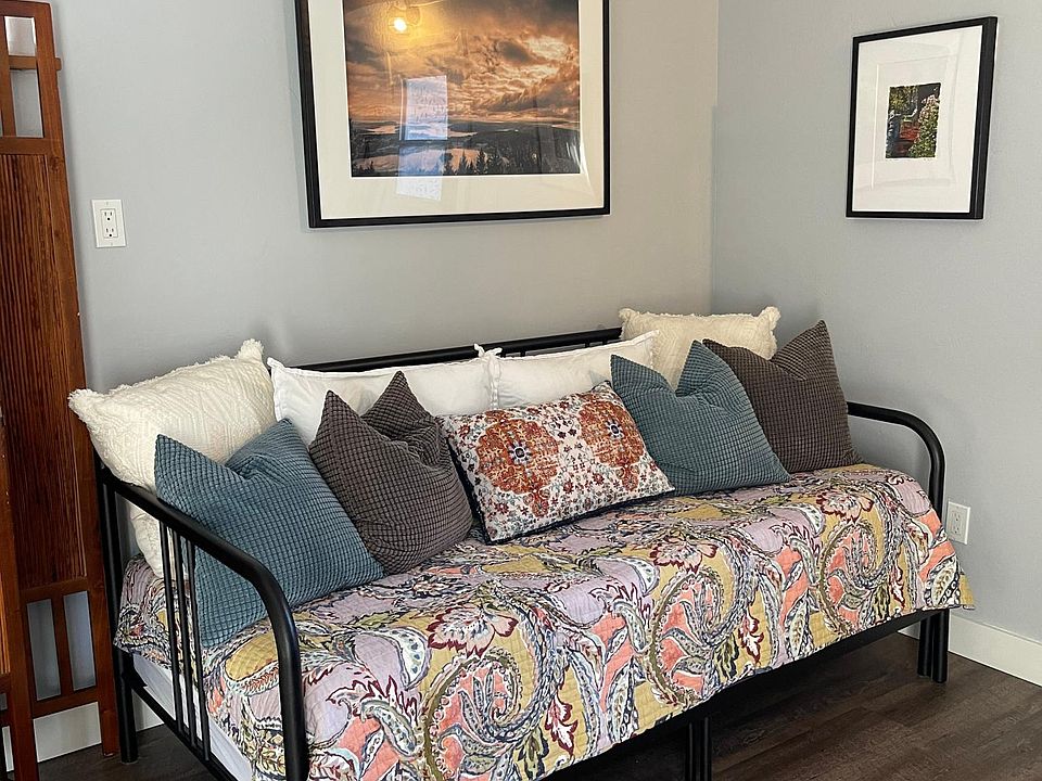 Comfy daybed converts to king for cozy days and nights warmed by the fire.
